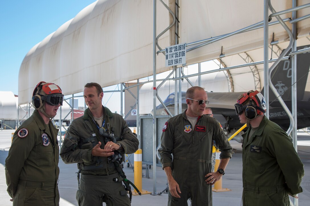 U.S. Airmen Maj. Caleb "Skeet" Guthman, and Capt. Timothy "Check" Six, pilots, attached to Hill Air Force Base, Utah, discuss upcoming exercises with U.S. Marines on MCAS Yuma, Ariz., June 26, 2018. The exercise tested, for the first time, the interoperability of loading weapon systems between the services F-35's. The U.S. Air Force operates with the F-35A Lightning II, while the U.S. Marine Corps operates with the F-35B Lightning II. (U.S. Marine Corps photo by Sgt. Allison Lotz)