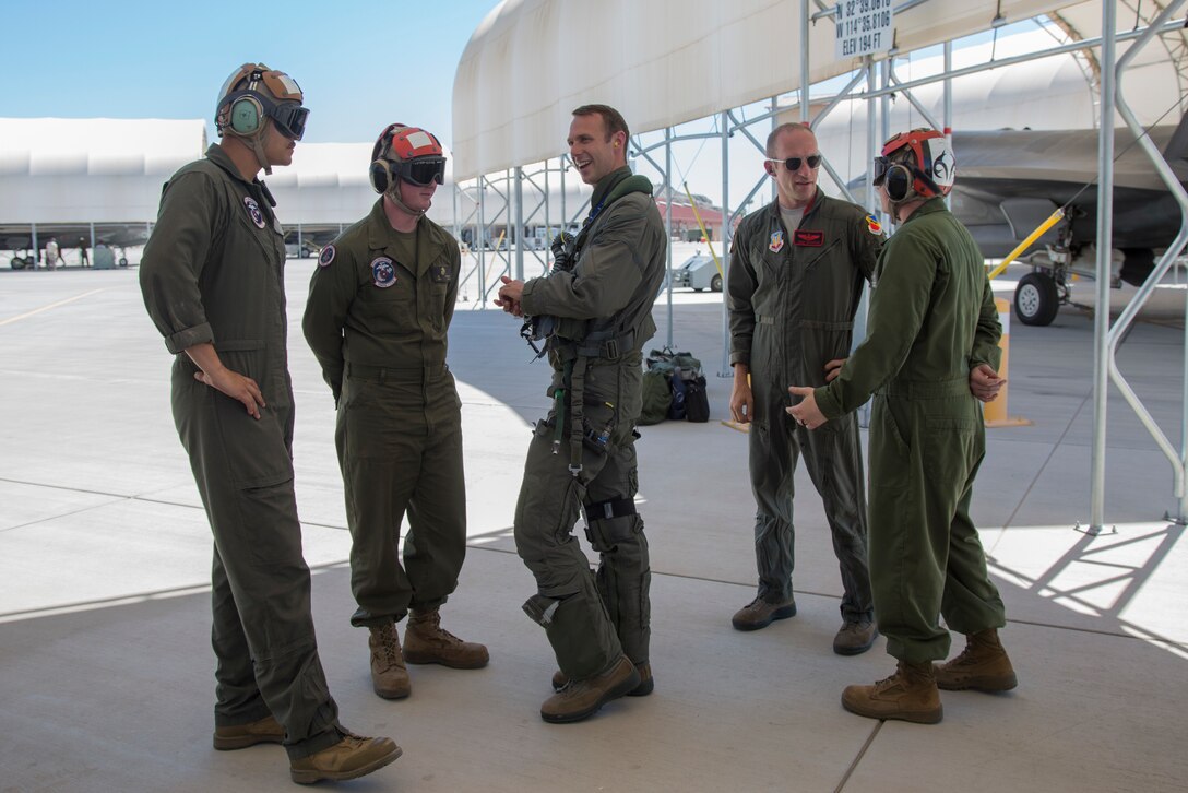 U.S. Airmen Maj. Caleb "Skeet" Guthman, and Capt. Timothy "Check" Six, pilots, attached to Hill Air Force Base, Utah, discuss upcoming exercises with U.S. Marines on MCAS Yuma, Ariz., June 26, 2018. The exercise tested, for the first time, the interoperability of loading weapon systems between the services F-35's. The U.S. Air Force operates with the F-35A Lightning II, while the U.S. Marine Corps operates with the F-35B Lightning II. (U.S. Marine Corps photo by Sgt. Allison Lotz)