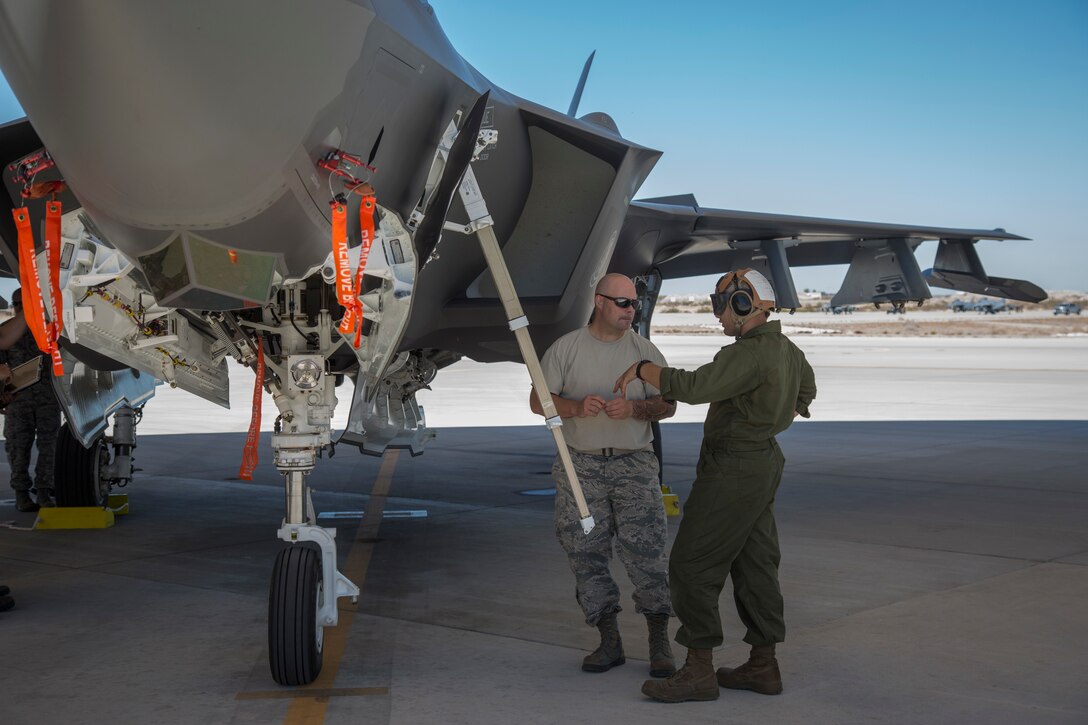 U.S. Marines with Marine Fighter Attack Squadron (VMFA) 122, Marine Corps Air Station (MCAS) Yuma, conduct exercises with U.S. Airmen attached to the 4th Aircraft Maintenance Unit, Hill Air Force Base, Utah, on MCAS Yuma, Ariz., June 26, 2018. The exercise tested, for the first time, the interoperability of loading weapon systems between the services F-35's. The U.S. Air Force operates with the F-35A Lightning II, while the U.S. Marine Corps operates with the F-35B Lightning II. (U.S. Marine Corps photo by Sgt. Allison Lotz)