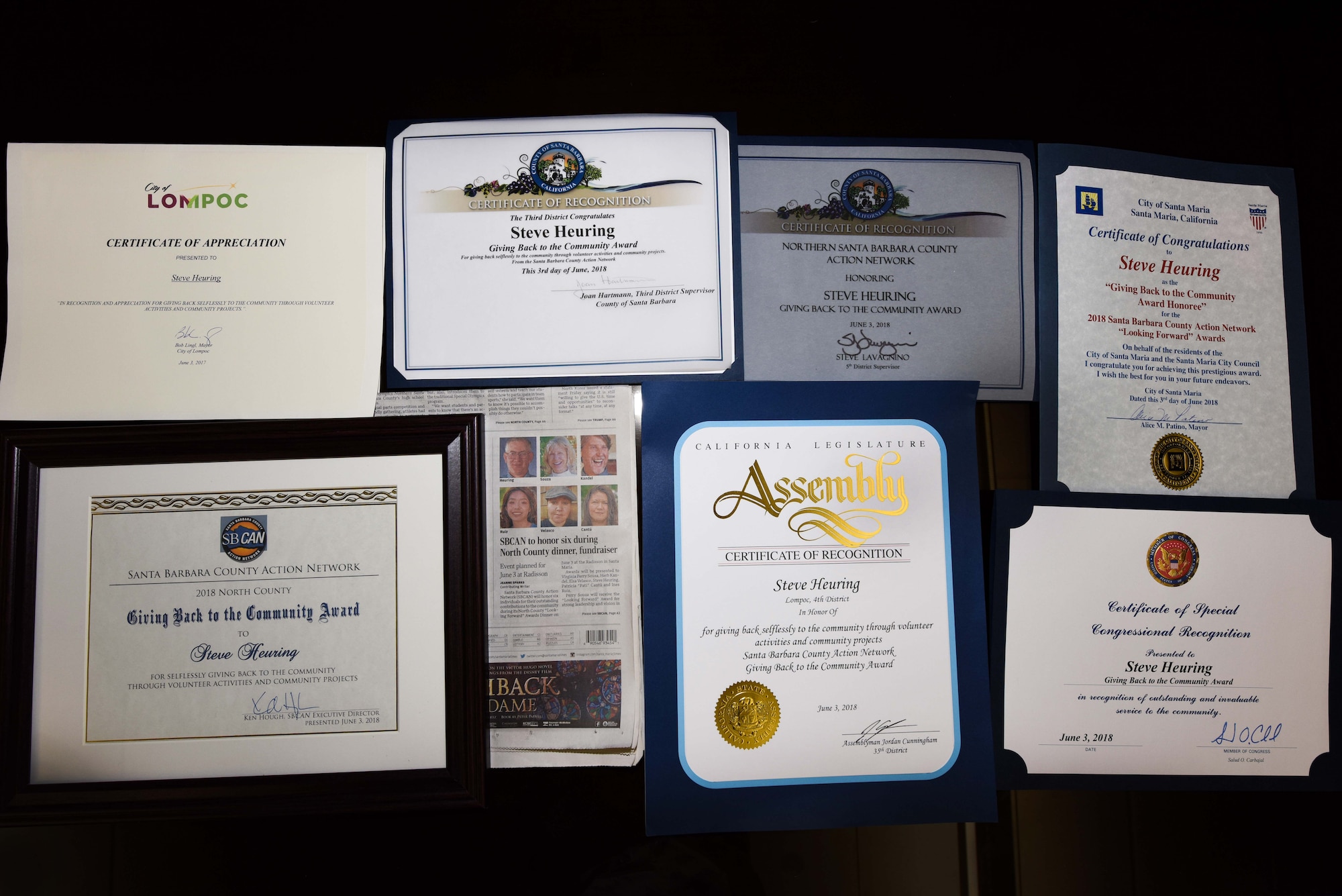 The accolades of Air Force Master Sgt. retired Steven Heuring, 30th Space Wing Public Affairs visual information specialist, are displayed on July 11, 2018, at Vandenberg Air Force Base, Calif. Heuring received the “Giving Back to the Community Award” presented by Santa Barbara County Action Network June 3, at the Santa Maria annual awards ceremony. (U.S. Air Force photo by Airman 1st Class Aubree Milks/Released)
