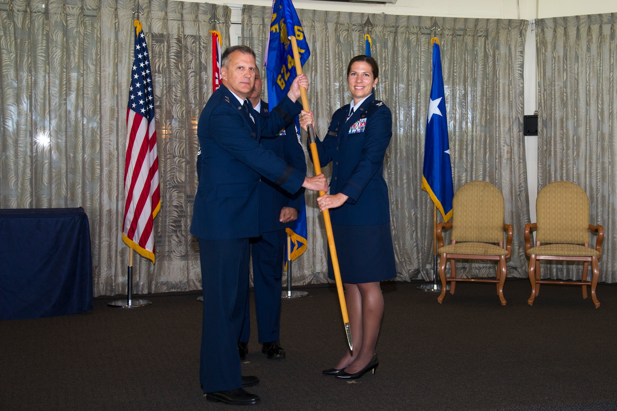 U.S. Air Force Maj. Gen. Randall Ogden, 4th Air Force commander, gives Col. Athanasia Shinas command of the 624th Regional Support Group during an assumption of command ceremony at Joint Base Pearl Harbor-Hickam, Hawaii, July 7, 2018.
