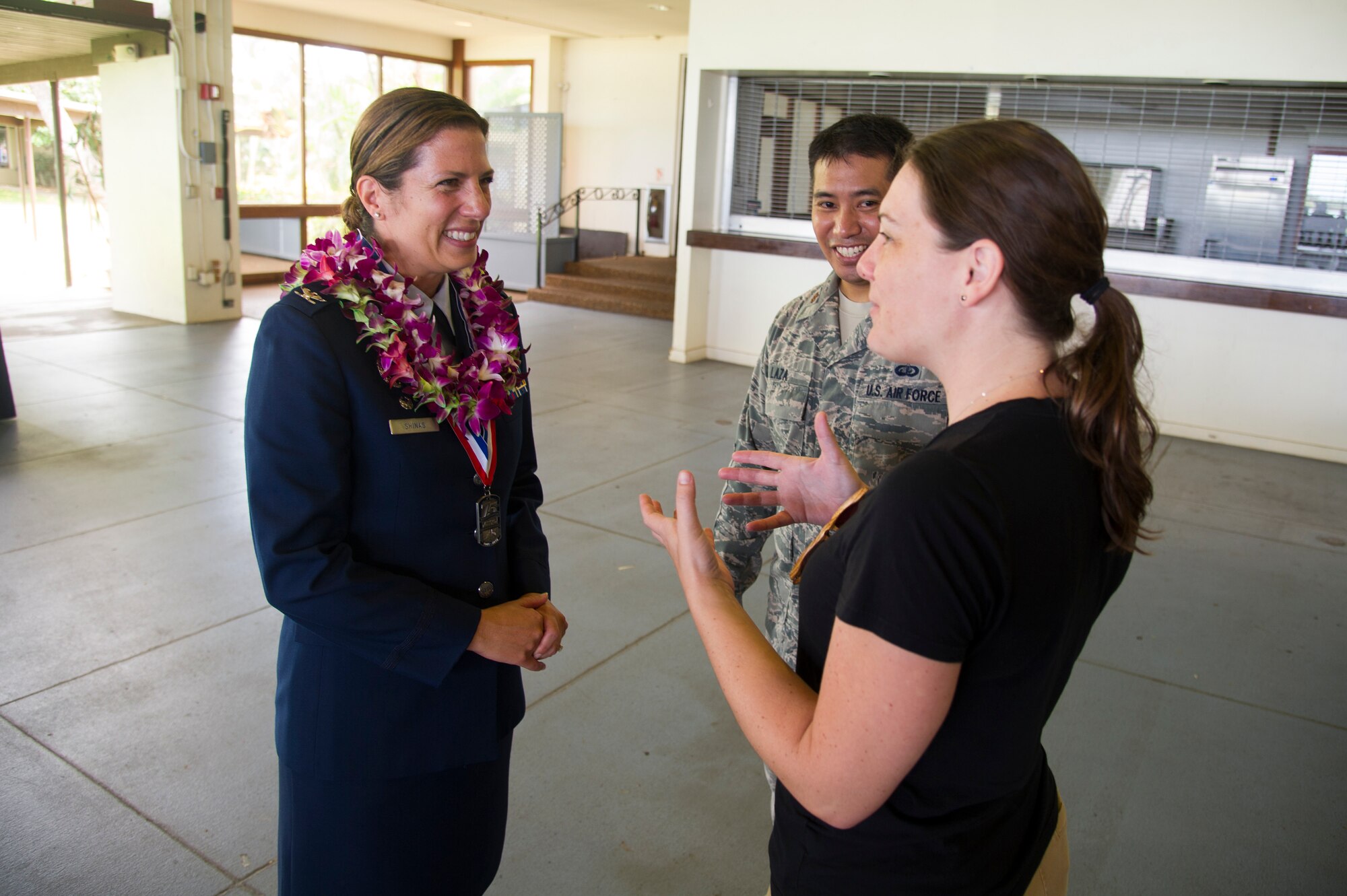 U.S. Air Force Col. Athanasia Shinas speaks with Maj. Elbert Laza and his wife, Christine Walters, following the 624th Regional Support Group assumption of command ceremony at Joint Base Pearl Harbor-Hickam, Hawaii, July 7, 2018.