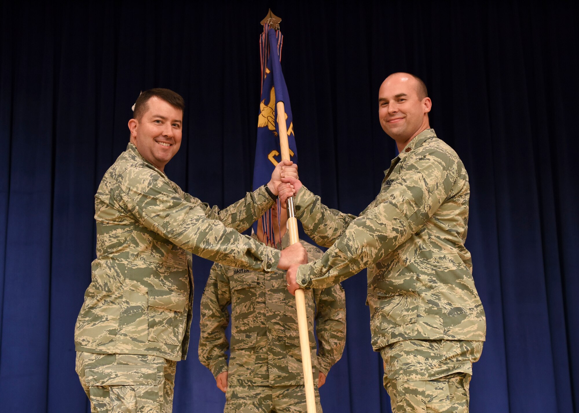 Col. William Betts, 51st Fighter Wing commander, gives the 51st Comptroller squadron guidon to Maj. Gregory White during a change of command ceremony at the Officers Club, July 2, 2018. During the ceremony, White took command of the 51st CPTS from Lt. Col. Christopher Jeffreys, 51st CPTS outgoing commander. (U.S. Air Force photo by Airman 1st Class Ilyana A. Escalona)