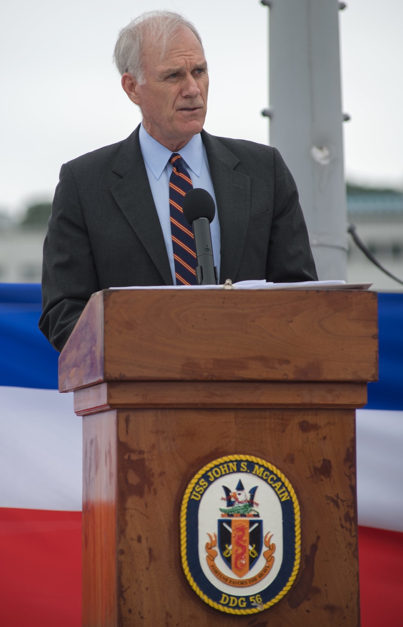 Secretary of the Navy Richard V. Spencer speaks during a ceremony aboard the guided-missile destroyer USS John S. McCain (DDG 56) to induct U.S. Sen. John S. McCain III into the ship's official namesake July 12, 2018. Expanding the namesake to include Senator McCain honors his family's three generations of dedicated service to the U.S. Navy.