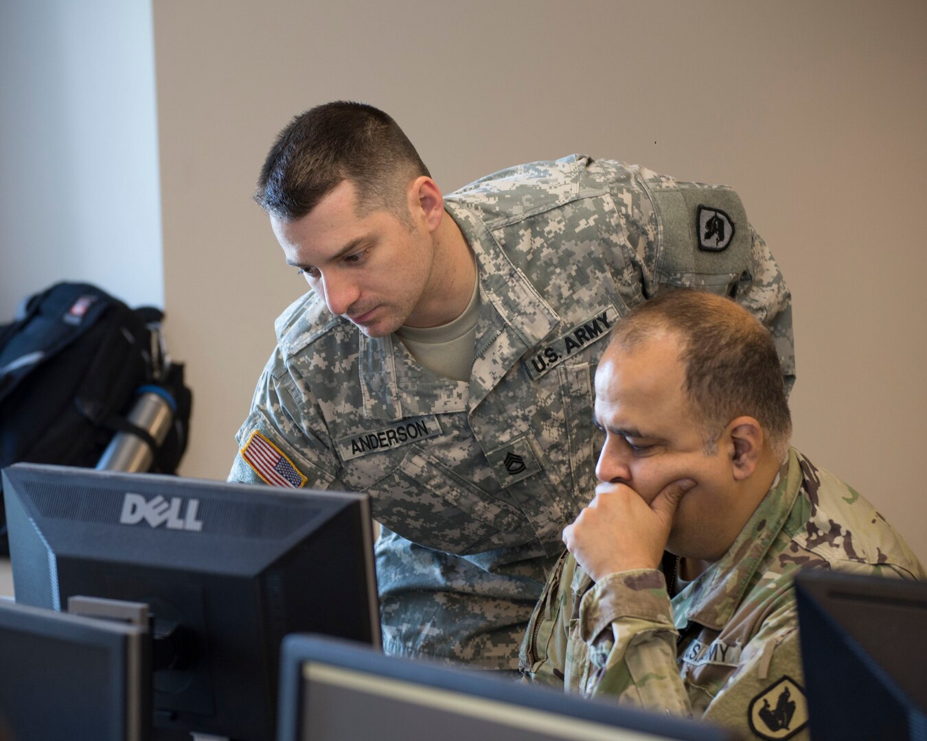 Sgt. 1st Class Samuel Anderson, Joint Force Headquarters, Washington National Guard, advises Cpt. Sameer Puri, 56th Theater Information Operations Group, during the International Collegiate Cyber Defense Invitational, July 6, 2018, at Highline Community College in Des Moines, Washington. Washington National Guard Soldiers attended the International Collegiate Cyber Defense Invitational to help educate information technology students on their responses to cyber-attacks.