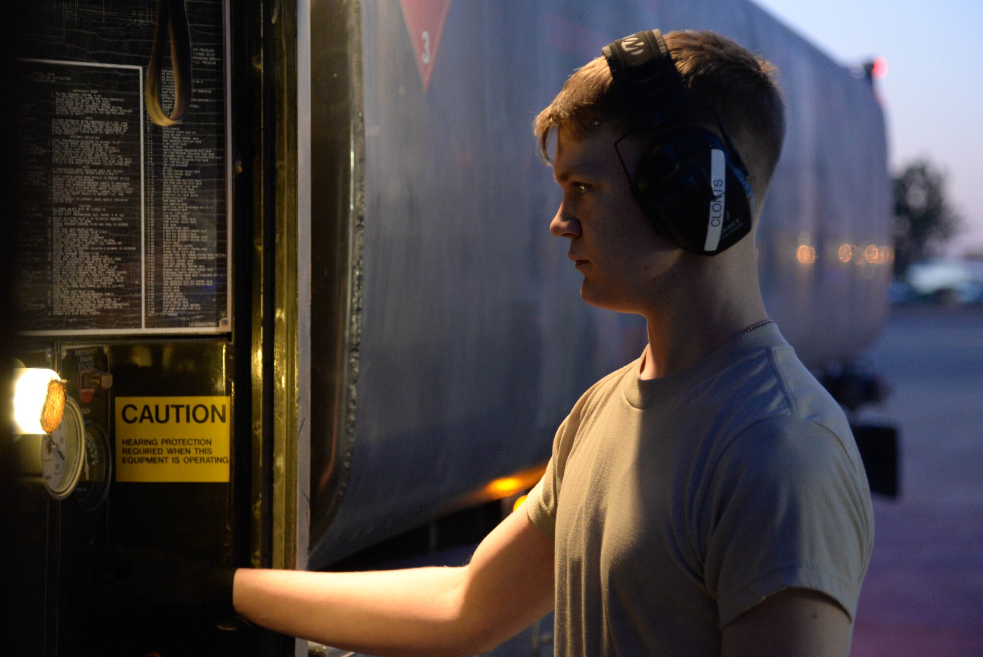 Airman 1st Class Jacob Clonts, 332nd Expeditionary Logistics Readiness Squadron Petroleum Oil Lubricant distributor, monitors the fuel output from a truck linked to an F-15E Strike Eagle on the flightline at an undisclosed location in Southwest Asia, July 6, 2018.