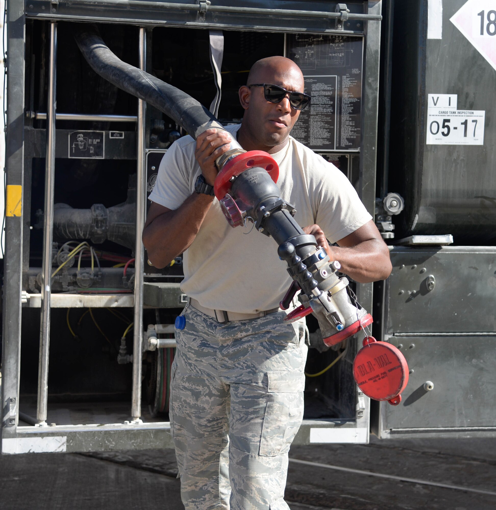 Airman 1st Class Luke Gayle, 332nd Expeditionary Logistics Readiness Squadron Petroleum Oil Lubricant distributor, pulls the fuel hose from a truck to an F-15E aircraft at an undisclosed location in Southwest Asia, July 7, 2018.