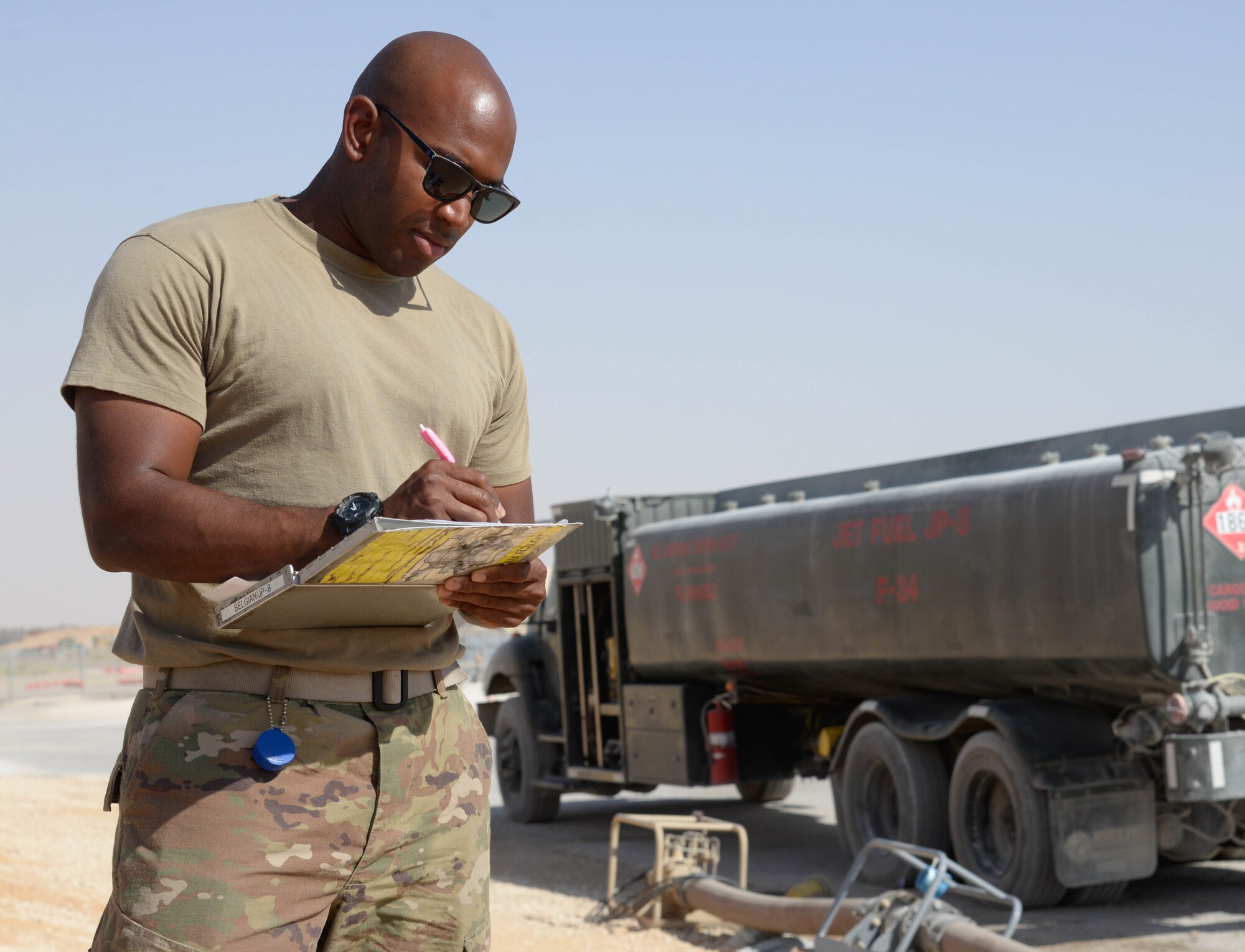 Airman 1st Class Luke Gayle, 332nd Expeditionary Logistics Readiness Squadron Petroleum Oil Lubricant distributor, annotates how much fuel is being transferred for the fuel truck that will support F-15E aircraft at an undisclosed location in Southwest Asia, July 6, 2018.