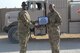 Lt. Col. Jamaal Mays, 332nd Expeditionary Logistics Readiness Squadron commander, presents the million gallon pumper certificate to Airman 1st Class Luke Gayle at an undisclosed location in Southwest Asia, July 6, 2018.