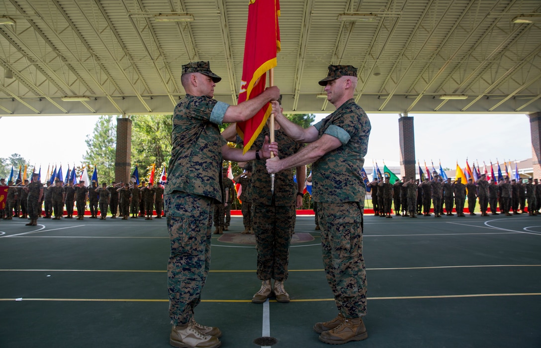 Lt. Col. Lawrence C. Coleman, off-going commanding officer, transfers command to Lt. Col. Scott O. Meredith, on-coming commanding officer, Wounded Warrior Battalion-East, at the WWBN-East Outdoor Basketball Pavilion on Marine Corps Base Camp Lejeune, N.C., June 21, 2018. The change of command formally transferred authorities and responsibilities of WWBN-E from Lt. Col. Lawrence C. Coleman to Lt. Col. Scott O. Meredith. (U.S. Marine Corps photo by Lance Cpl. Nathan Reyes)