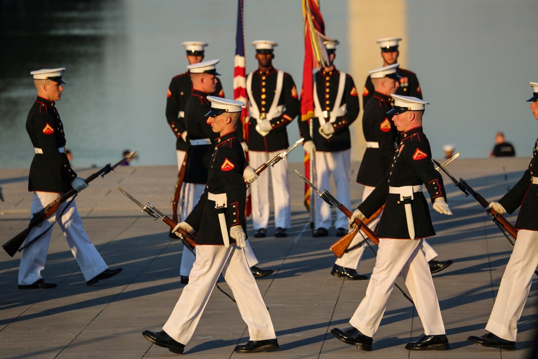 Marines with the U.S. Marine Corps Silent Drill Platoon execute precision rifle drill movements during a Tuesday Sunset Parade at the Lincoln Memorial, Washington D.C., July 10, 2018. The guest of honor for the parade was the former Vice President of the U.S., Joe Biden, and the hosting official was the Staff Judge Advocate to the Commandant of the Marine Corps, Maj. Gen. John R. Ewers Jr.