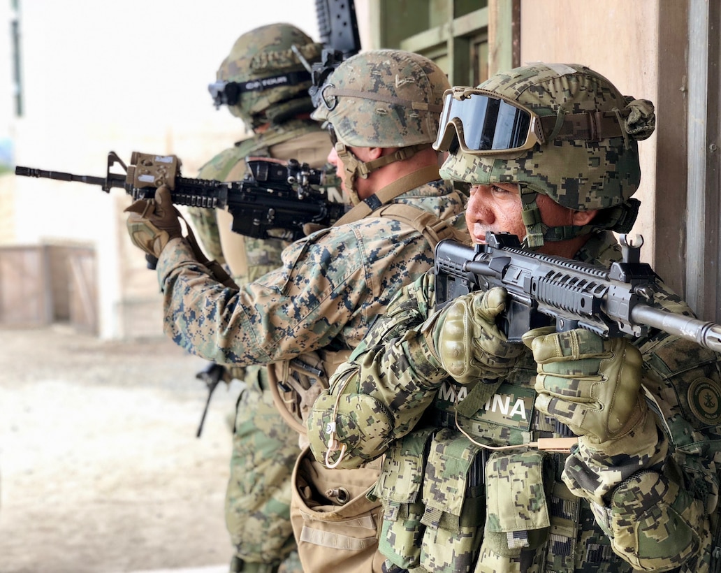 U.S. Marines with 2nd Battalion, 1st Marine Regiment, and Mexican marines assigned to the Amphibious Marine Infantry Brigade stand security during an integrated squad exercise with as they navigate the infantry immersion trainer during Rim of the Pacific exercise at Marine Corps Base Camp Pendleton, California, July 9, 2018. The IIT provided the Marines with “hands on” practical application of tactical skills and decision making in an immersive, scenario-based training environment. RIMPAC demonstrates the value of amphibious forces and provides high-value training for task-organized, highly-capable Marine Air-Ground Task Forces enhancing the critical crisis response capability of U.S. forces and partners globally. Twenty-five nations, 46 ships, five submarines, about 200 aircraft and 25,000 personnel are participating in RIMPAC from June 27 to Aug. 2 in and around the Hawaiian Islands and Southern California.