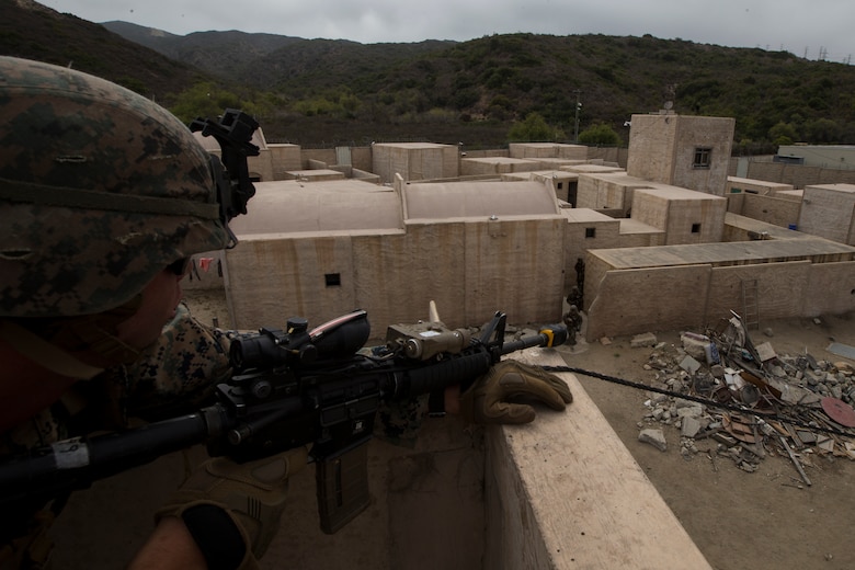 U.S. Marine Corps Lance Cpl. Riley McQuaid, an infantry Marine with 2nd Battalion, 1st Marine Regiment, provides security for another fireteam at an Infantry Immersion Trainer during Rim of the Pacific exercise on Marine Corps Base Camp Pendleton, California, July 10, 2018. The IIT provided the Marines with “hands on” practical application of tactical skills and decision making in an immersive, scenario-based training environment. RIMPAC demonstrates the value of amphibious forces and provides high-value training for task-organized, highly capable Marine Air-Ground Task Forces enhancing the critical crisis response capability of U.S. forces and partners globally. Twenty-five nations, 46 ships, five submarines, about 200 aircraft and 25,000 personnel are participating in RIMPAC from June 27 to Aug. 2 in and around the Hawaiian Islands and Southern California.