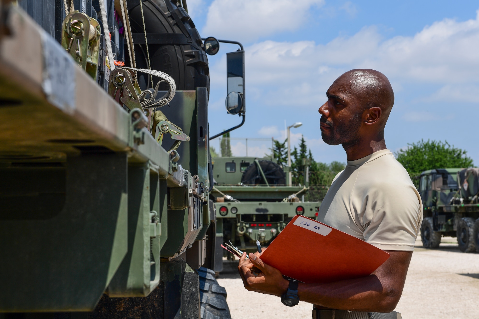 An logistics Airman inspects a piece of equipment against a reference sheet at Incirlik Air Base, Turkey