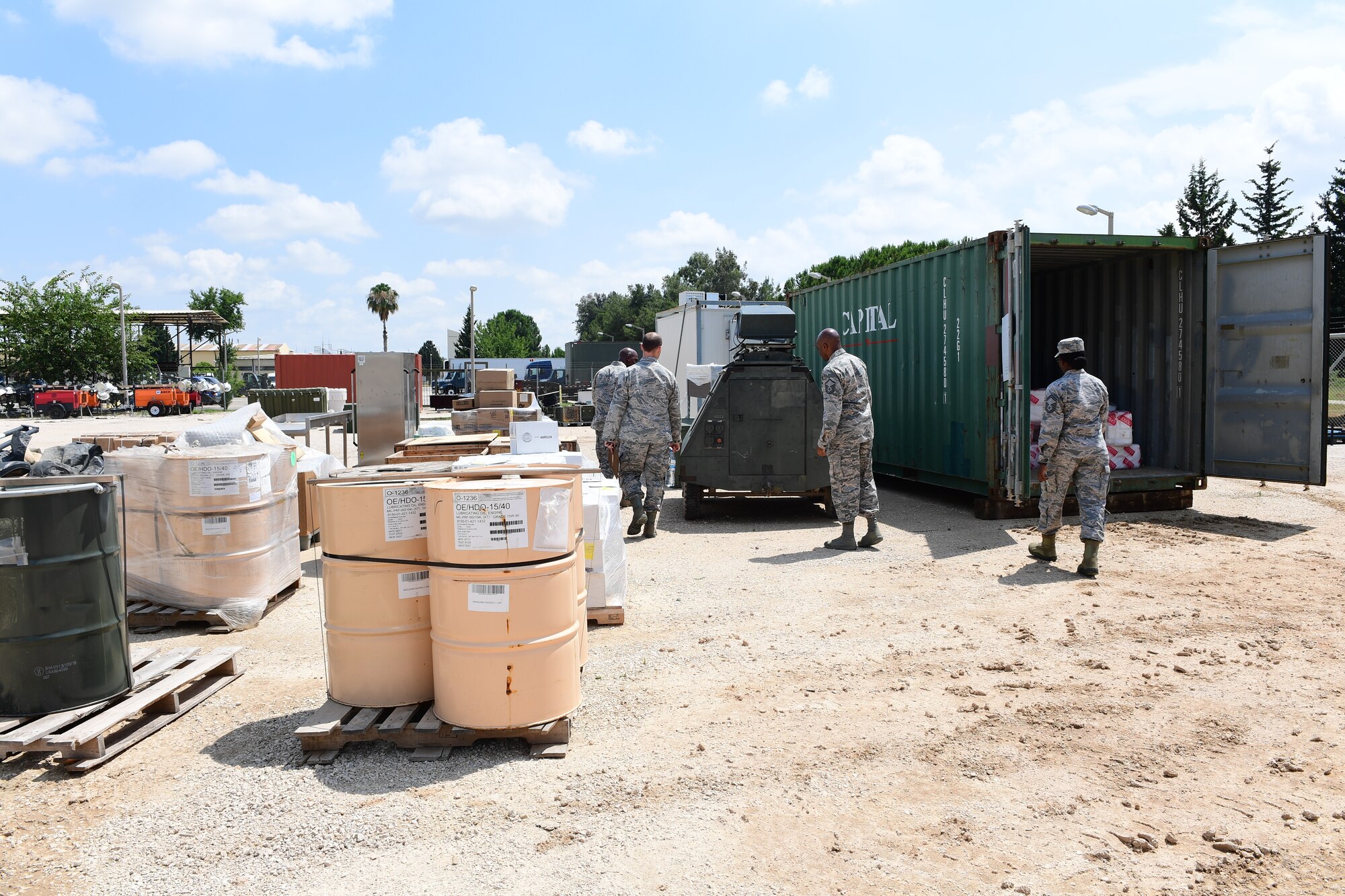 Three Logistics Airmen prepare to Inspect equipment near the flight line at Incirlik Air Base, Turkey