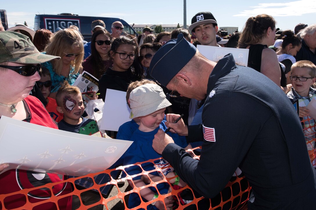 Air Force Lt. Col.  Kevin Walsh signs a fan’s t-shirt after a performance.