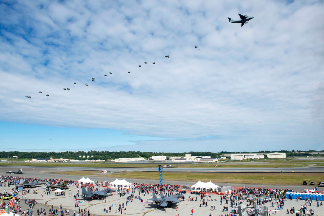 Soldiers provide an airborne operation demonstration as they jump from a Globemaster III.