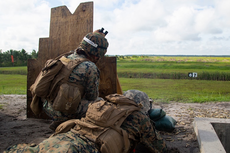 U.S. Marine Corps Sgt. Irene Ragland, combat instructor, Fox Company, Marine Combat Training Battalion (MCT), School of Infantry-East, monitors a Marine firing a M16A4 Service Rifle during Table 3 and 4 marksmanship training, Camp Lejeune, N.C., June 27, 2018. MCT conducts standards-based common combat skills training of entry-level Marines in order to create riflemen for service throughout the Marine Corps. (U.S. Marine Corps photo by Lance Cpl. Ashley Gomez)