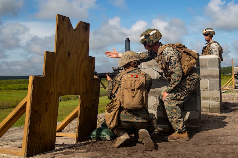 U.S. Marine Corps Sgt. Thorpe Lichtenberg, combat instructor, Fox Company, Marine Combat Training Battalion (MCT), School of Infantry-East, monitors a Marine firing a M16A4 Service Rifle during Table 3 and 4 marksmanship training, Camp Lejeune, N.C., June 27, 2018. MCT conducts standards-based common combat skills training of entry-level Marines in order to create riflemen for service throughout the Marine Corps. (U.S. Marine Corps photo by Lance Cpl. Ashley Gomez)