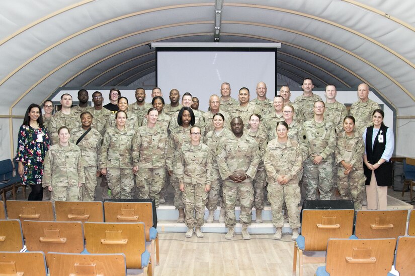Soldiers with Headquarters and Headquarters Battalion, 28th Infantry Division pause for a photo with Kuwait Association for the Care of Children in Hospital (KACCH) Deputy Director Banafsheh Azizi (right) and Volunteer Coordinator Basma Ismailand (left) after a volunteer orientation on June 25.