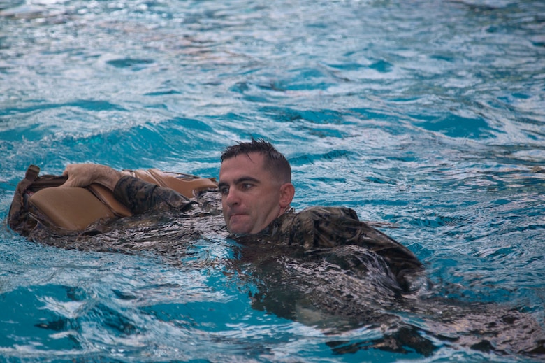 A Marine with Headquarters and Support Battalion, Marine Corps Installations East, Marine Corps Base Camp Lejeune, participate in the basic swim qualification course at the Area 5 Training Tank on MCB Camp Lejeune, N.C., July 2, 2018. The Marine Corps Water Survival Training Program employs water survival skills of increasing levels of ability designed to help Marines survive in the water. (U.S. Marine Corps photo by Lance Cpl. Ashley D. Gomez)