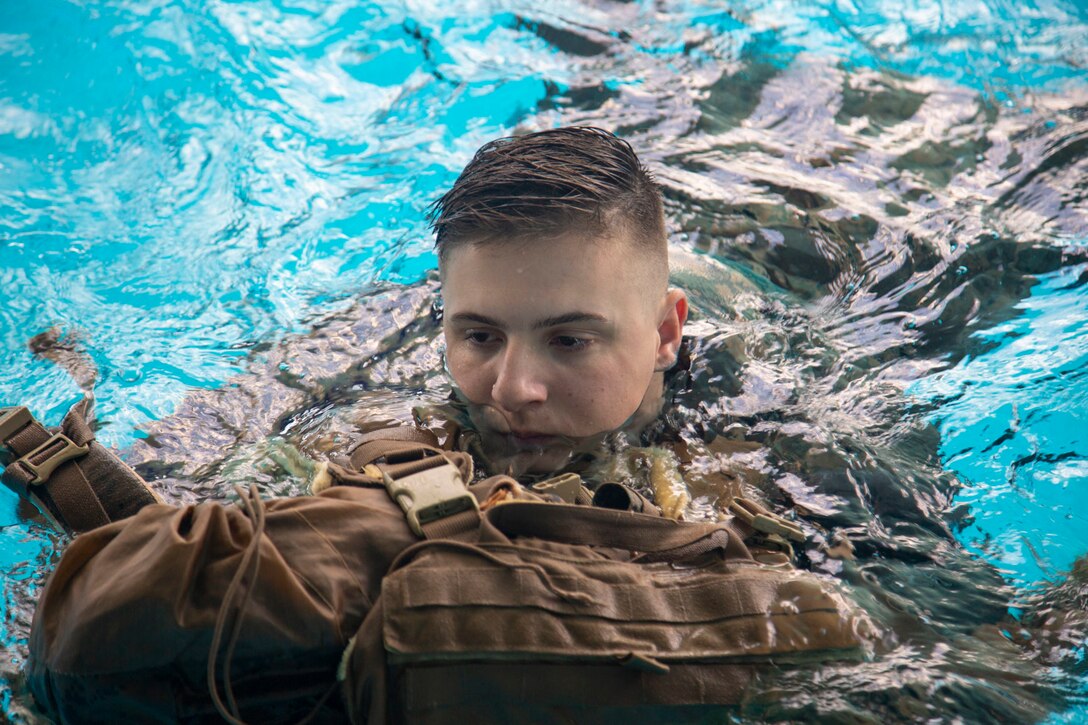 A Marine with Headquarters and Support Battalion, Marine Corps Installations East, Marine Corps Base Camp Lejeune, participates in the basic swim qualification course at the Area 5 Training Tank on MCB Camp Lejeune, N.C., July 2, 2018. The Marine Corps Water Survival Training Program employs water survival skills of increasing levels of ability designed to help Marines survive in the water. (U.S. Marine Corps photo by Lance Cpl. Ashley D. Gomez)
