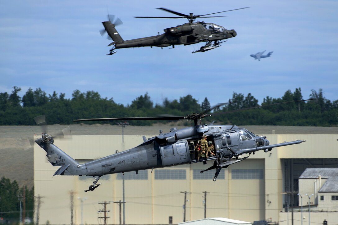 Two helicopters approach the flight line before landing.