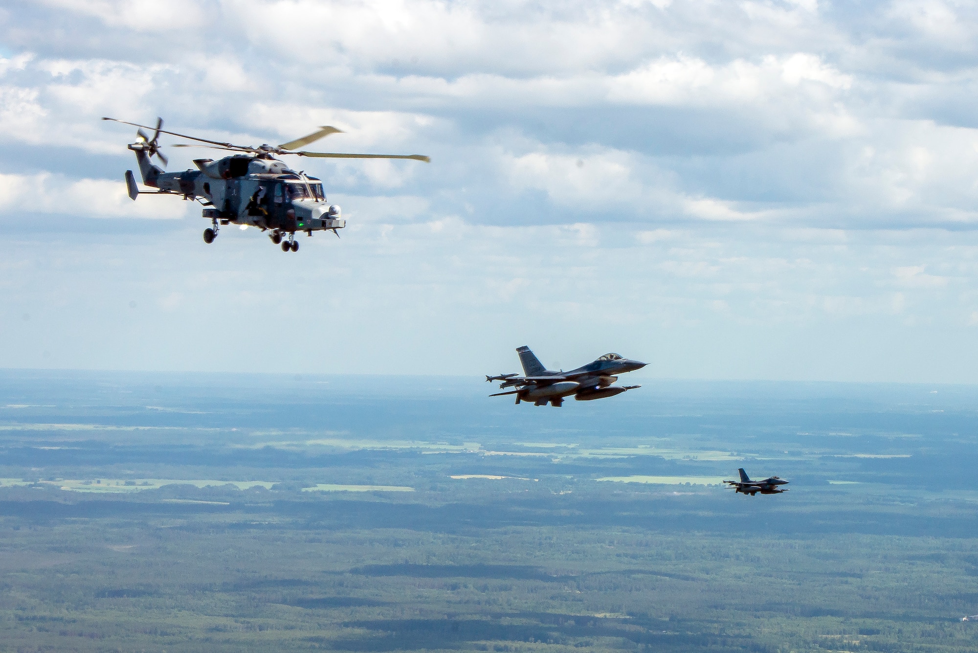 British Wildcat helicopter performs a training exercise with two American F-16's from the Colorado Air National Guard, June 20, 2018 as part of Saber Strike 18.