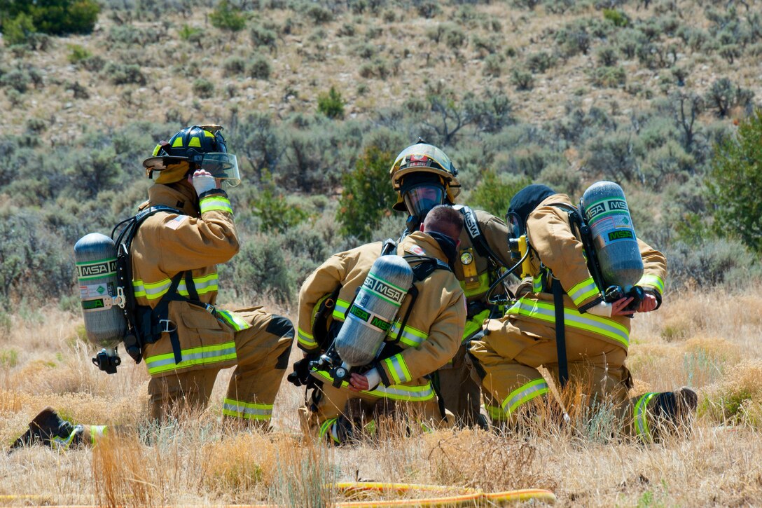 Soldiers discuss firefighting techniques while taking a break from training.