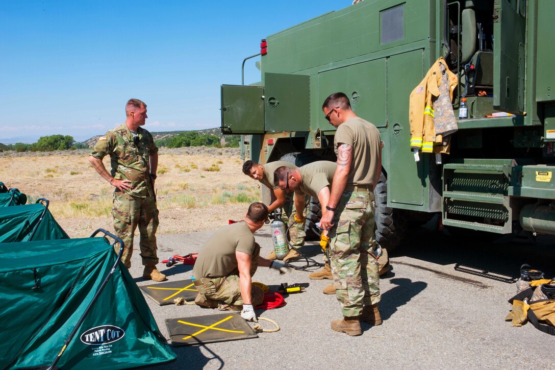 Soldiers check their equipment for accountability after conducting firefighting training.