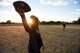 A couple throws a football ahead of Travis Air Force Base, Calif.'s Independence Day celebration July 5, 2018. The celebration, including food trucks, a rock wall, and a disc jockey, concluded with a drone light show sponsored by Intel. (U.S. Air Force photo by Airman 1st Class Christian Conrad)