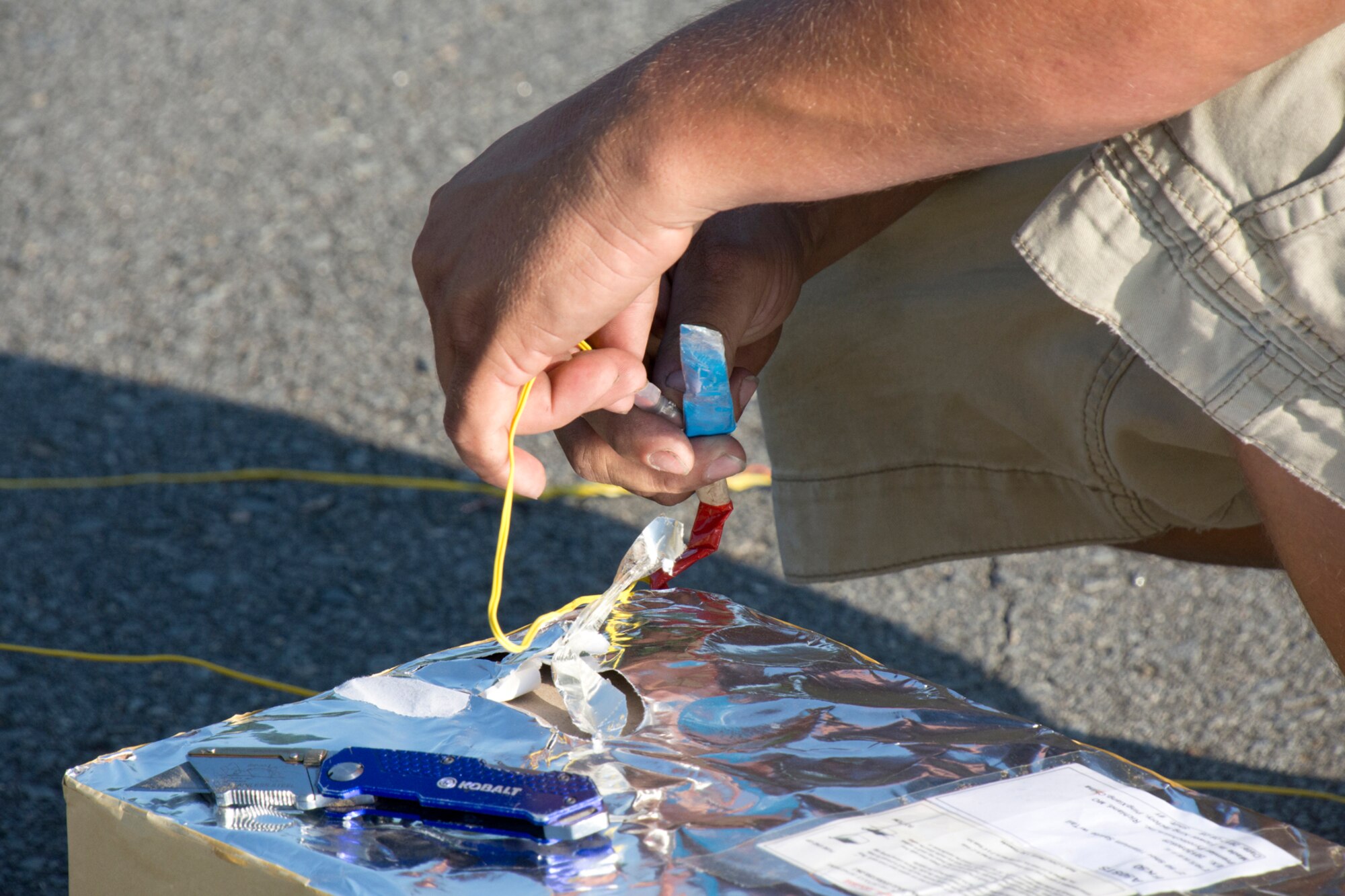 Jarrod Arnall, , a pyrotechnician for Premier Pyrotechnics, Inc., of Richland, Missouri, wires one of nine cake fireworks to be used for the finale of the Liberty Fest celebration at Little Rock Air Force Base, Ark., July 7, 2018.