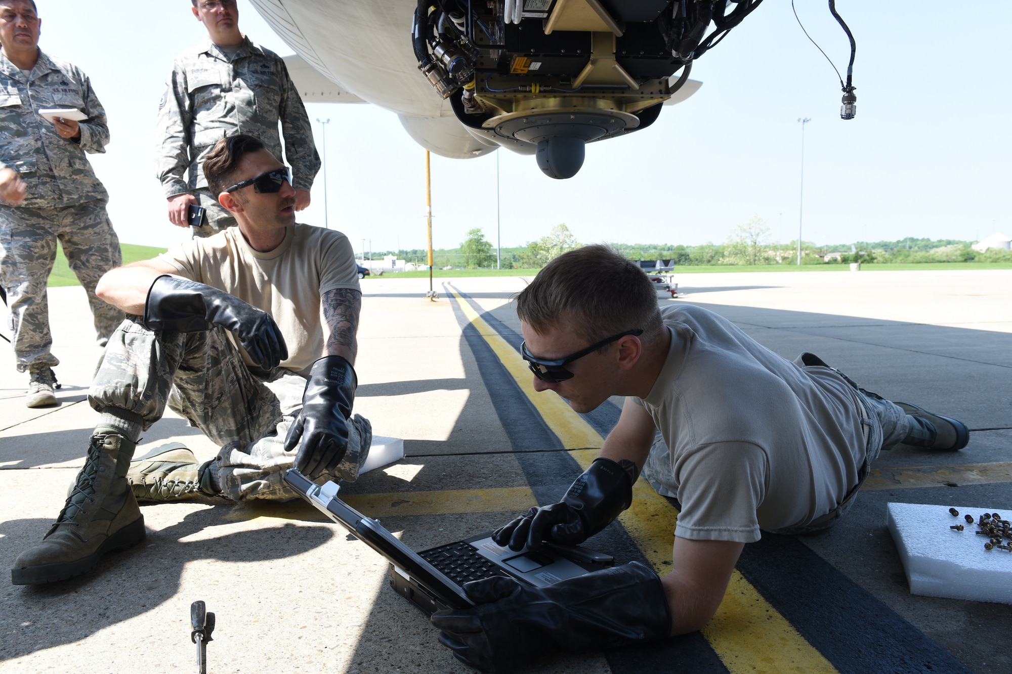 Senior Master Sgt. Joey Urena from the Air National Guard Test Center in Tucson, Ariz., and Master Sgt. Tony Burch from KC-135 System Program Office at Tinker Air Force Base, Okla., observe Pennsylvania Air National Guardsmen Master Sgt. Bryan Schulz and Tech. Sgt. Cameron of the 171st Air Refueling Wing perform maintenance on the Large Aircraft Infrared Counter-Measure third generation prototype system May 24, 2018 in Coraopolis, Pa. (U.S. Air National Guard Photo by Senior Airman Bryan Hoover)