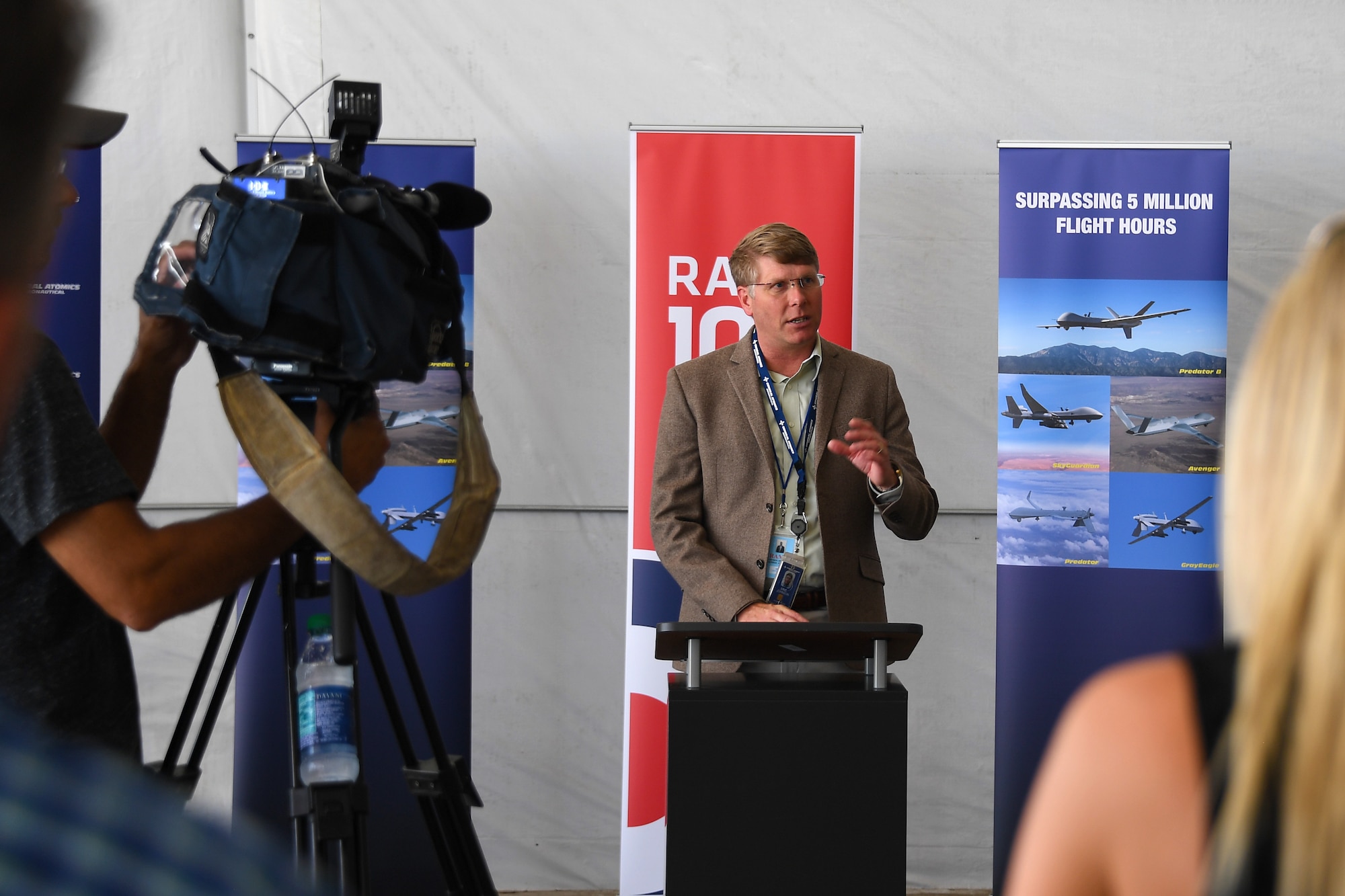 Eric Johnson, General Atomics Aeronautical Systems program manager, thanks a crowd of community leaders and guests in attendance at the launch of an MQ-9B SkyGuardian from Grand Sky Air Park July 10, 2018, on Grand Forks Air Force Base, North Dakota. The launch marks the first trans-Atlantic flight for a high-altitude, long-endurance remotely-piloted aircraft. (U.S. Air Force photo by Airman 1st Class Elora J. Martinez)