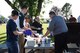 Volunteers, along with employees from J.R. Rockers, assist with cooking hamburgers and providing beverages for guests at Freedom Fest July 3, 2018, on Grand Forks Air Force Base, North Dakota. Because the initial food truck was unable to attend, these volunteers came to the rescue, and there were over 300 hamburgers sold at this event. (U.S. Air Force photo by Airman 1st Class Melody Wolff)