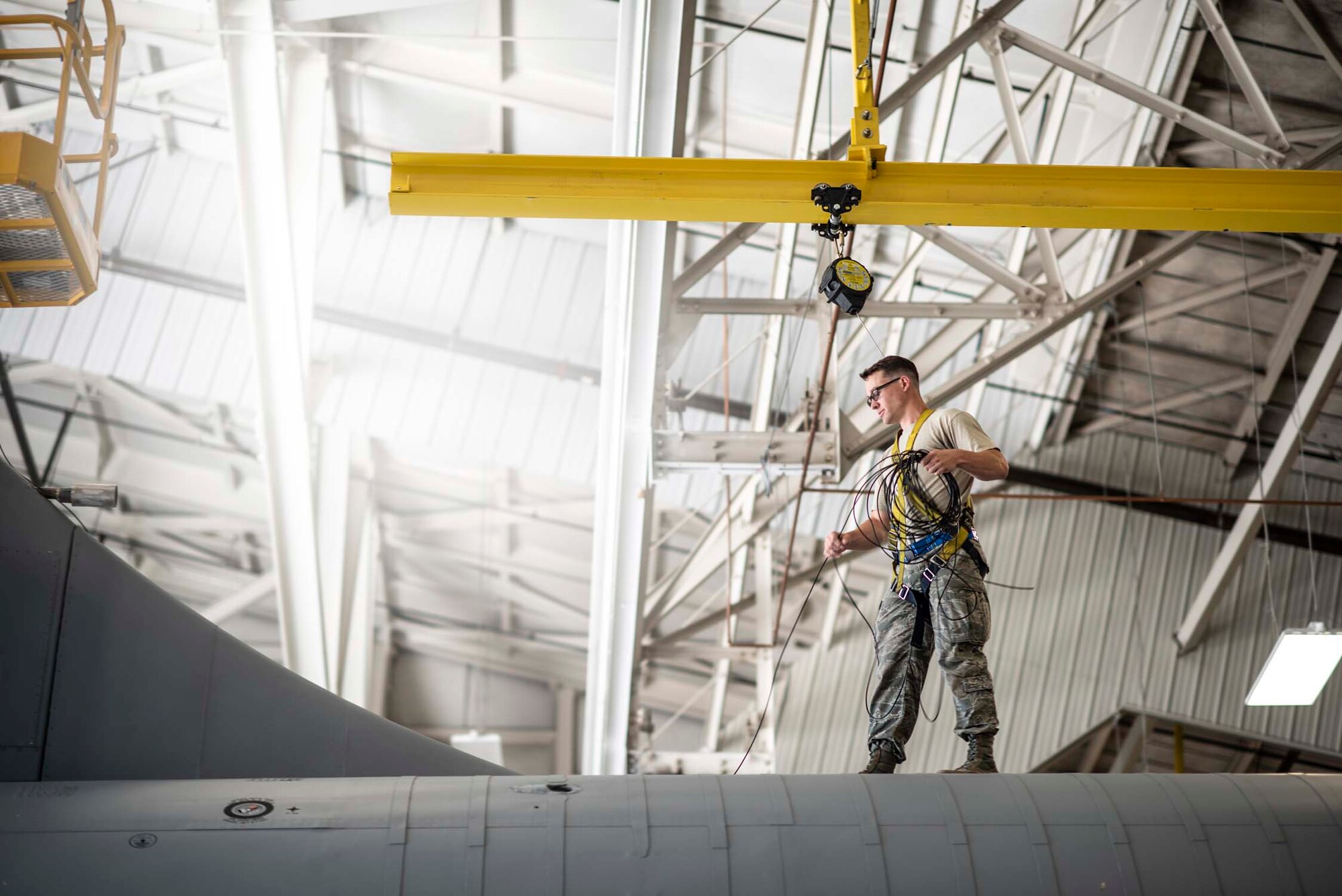 Staff Sgt. Shawn Hines, an avionics systems specialist with the 141st Maintenance Squadron, installs a new high frequency long wire antenna on a KC-135 Stratotanker during an aircraft inspection June 5, 2018 at Fairchild Air Force Base, Wash. Hines is installing the antenna while the KC-135 undergoes an isochronal inspection; the process of dismantling, inspecting, repairing and sometimes modifying the tanker every 24 months. (U.S. Air National Guard photo by Tech. Sgt. Kayleigh Phillips)