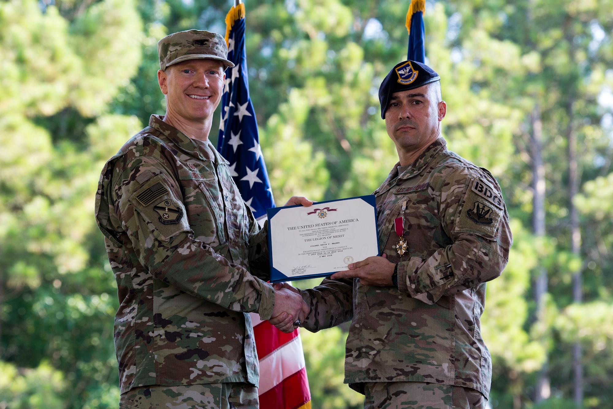 Col. Paul Birch, left, 93d Air Ground Operations Wing commander, and Col. Kevin Walker, 820th Base Defense Group (BDG) outgoing commander, pose for a photo during a change of command ceremony, July 12, 2018, at Moody Air Force Base, Ga. The ceremony represents the formal passing of responsibility, authority and accountability of command from one officer to another. Col. Benito Barron, 820th BDG commander, who recently relinquished his duties as the Chief of the Homeland Defense and Protection Division for Headquarters United States Northern Command, will now command the 820th BDG. The 820th BDG is the Air Force’s only unit specifically designed to provide fully integrated defense operations. (U.S. Air Force photo by Airman 1st Class Erick Requadt)