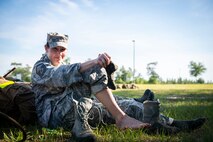 Master Sgt. Kay Williams, 919th Special Operations Security Forces Squadron, treats blisters on her feet moments after she and fellow team members completed a seven-mile ruck march May 5, 2018 near Duke Field, Fla.