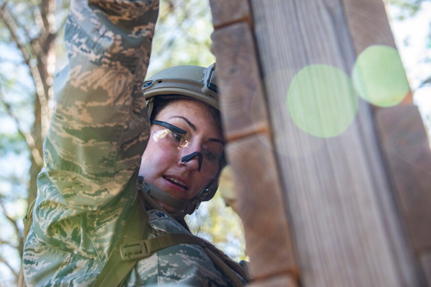 Master Sgt. Kay Williams, 919th Special Operations Security Forces Squadron takes on the climbing wall obstacle at a course May 5, 2018 on Eglin Air Force Base, Fla.