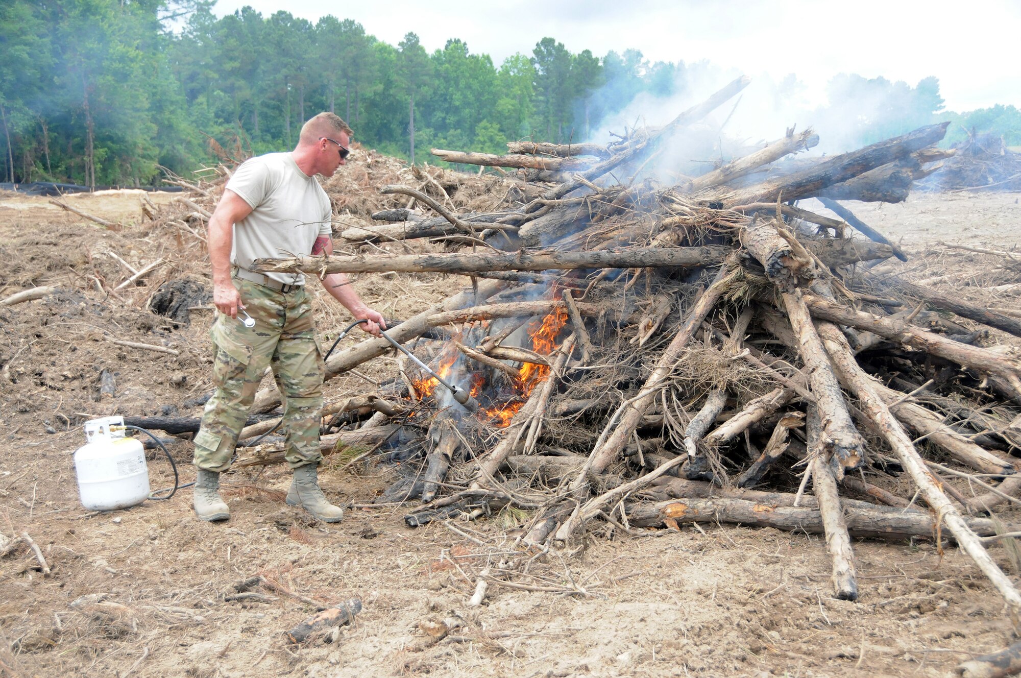 Tech. Sgt. Sean Sullivan, 445th Civil Engineer Squadron firefighter, burns brush cleared from a 40-acre area at Camp Kamasa, Crystal Springs, Mississippi, June 6, 2018.