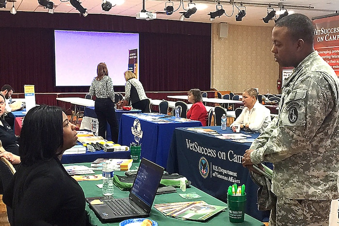Two people have a discussion at a table.