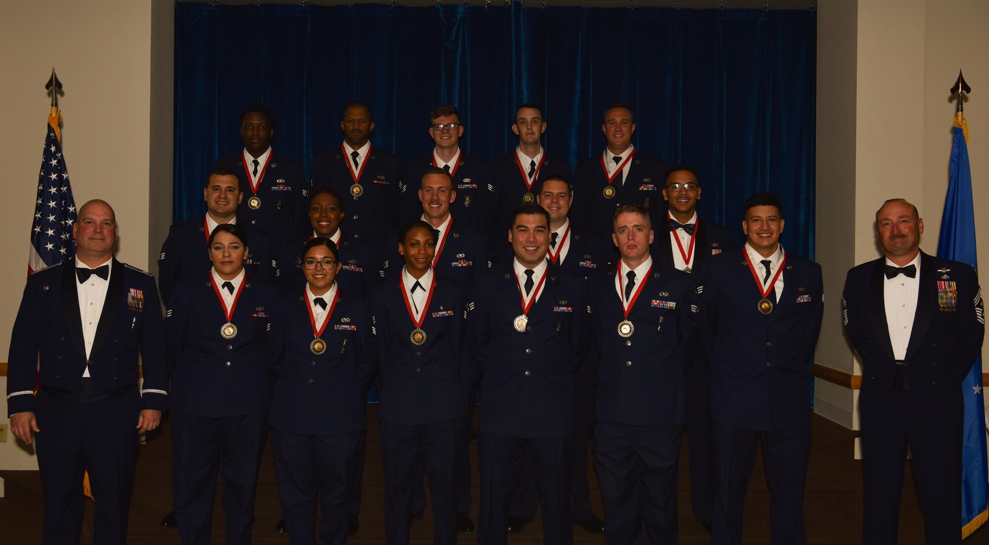 Col. Brian Young, 90th Missile Wing vice commander, and Chief Master Sgt. Thomas Good, 20th Air Force command chief, pose with the graduating Airman Leadership School Class 18-F students in the Trail's End Event Center on F.E. Warren Air Force Base, Wyo., May 18, 2016. Enlisted Airmen must complete the rigorous professional military education course to become supervisors of other Airmen. (U.S. Air Force photo by Airman 1st Class Braydon Williams)