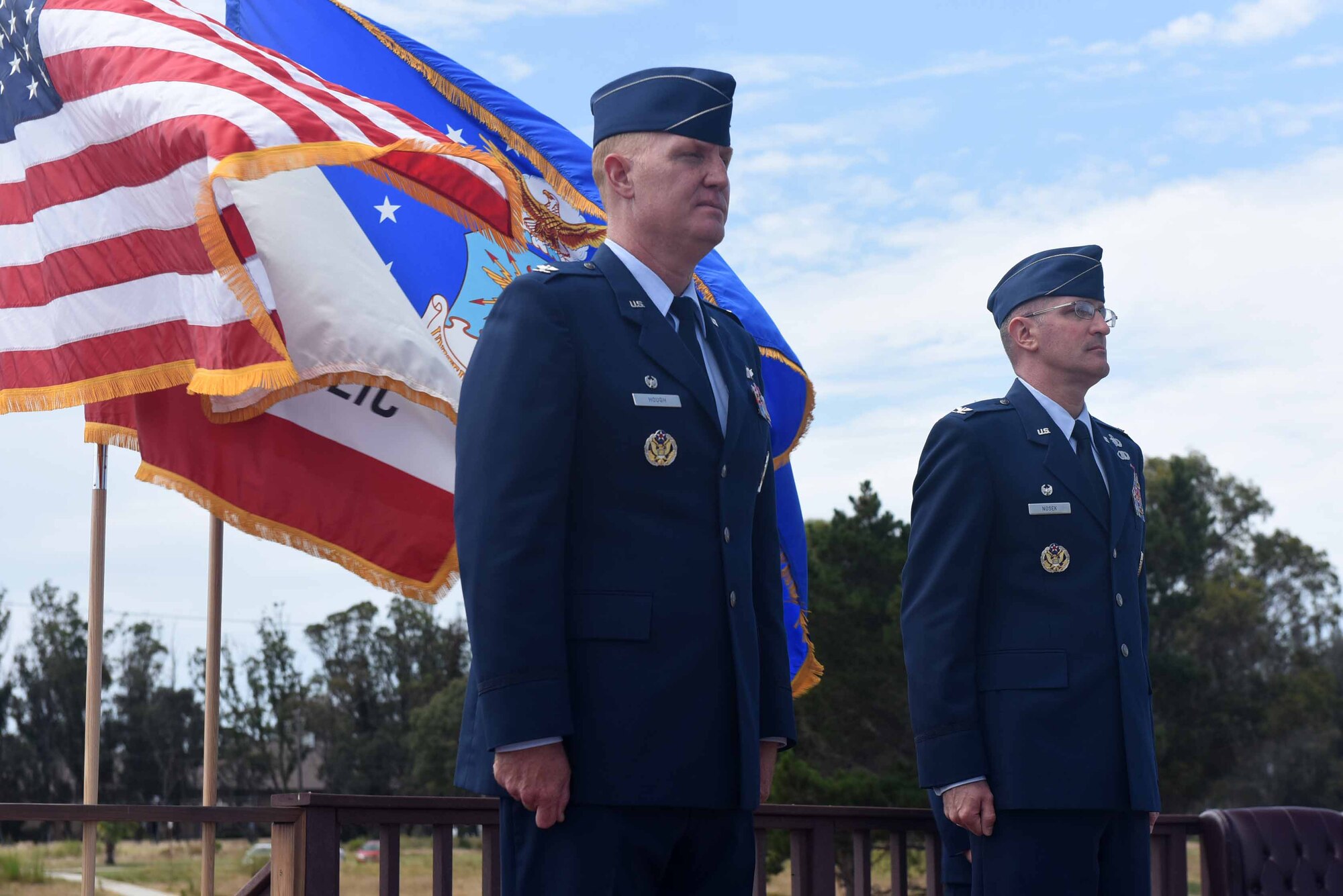Col. Michael Hough, 30th Space Wing commander, and Col. Paul Nosek, 30th Mission Support Group outgoing commander, stand at attention during a change of command ceremony on July 12, 2018, at Vandenberg Air Force Base, Calif. The 30th MSG provides security, law enforcement, disaster response, civil engineer, base services, mission support, morale services, contracting, and logistical support. (U.S. Air Force photo by Tech. Sgt. Jim Araos/Released)