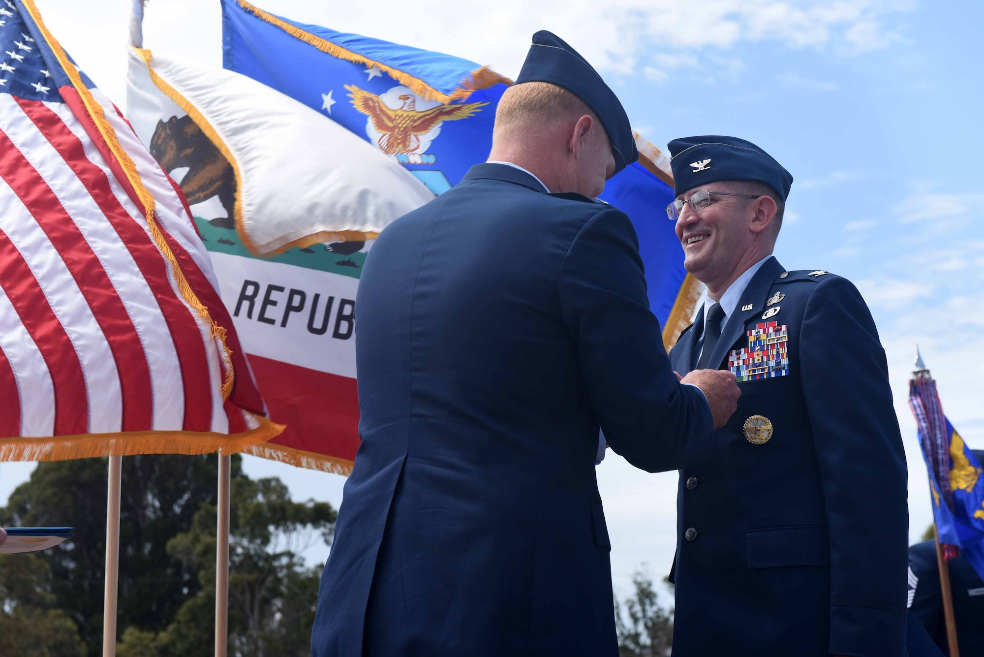 Col. Michael Hough, 30th Space Wing commander, presents the legion of merit to Col. Paul Nosek, 30th Mission Support Group outgoing commander, during the 30th MSG change of command ceremony on July 12, 2018, at Vandenberg Air Force Base, Calif. The 30th MSG provides security, law enforcement, disaster response, civil engineer, base services, mission support, morale services, contracting, and logistical support. (U.S. Air Force photo by Tech. Sgt. Jim Araos/Released)