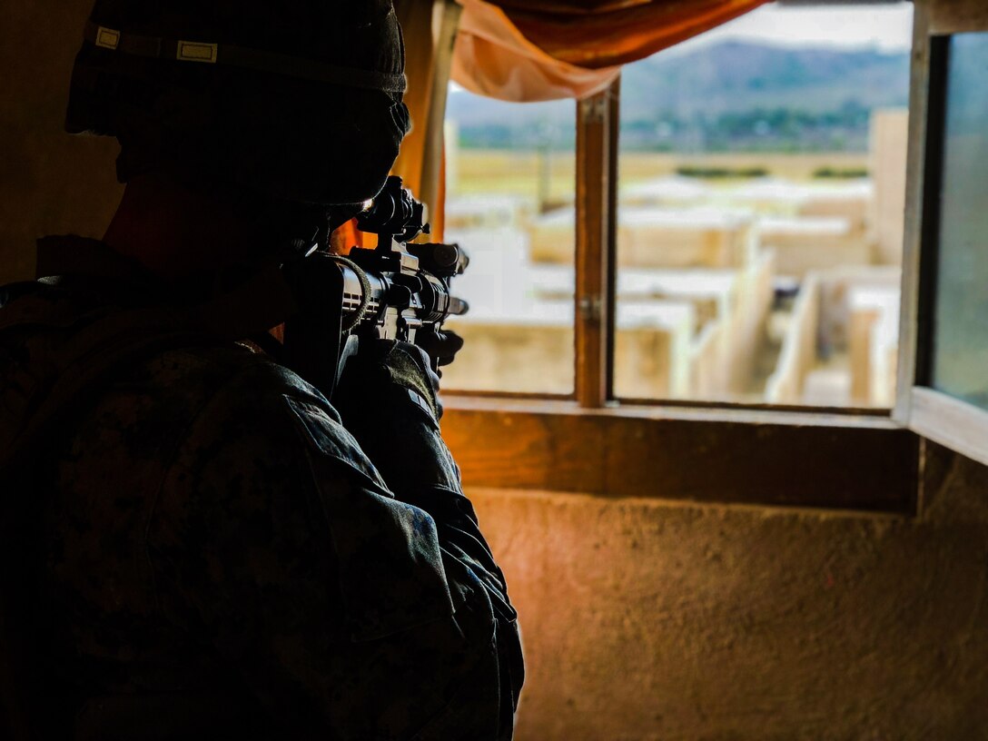 A U.S. Marine with 2nd Battalion, 1st Marine Regiment, provides overwatch during an integrated squad exercise with Mexican marines assigned to the Amphibious Marine Infantry Brigade as they navigate the infantry immersion trainer during Rim of the Pacific exercise at Marine Corps Base Camp Pendleton, California, July 9, 2018. The IIT provided the Marines with “hands on” practical application of tactical skills and decision making in an immersive, scenario-based training environment. RIMPAC demonstrates the value of amphibious forces and provides high-value training for task-organized, highly capable Marine Air-Ground Task Forces enhancing the critical crisis response capability of U.S. forces and partners globally. Twenty-five nations, 46 ships, five submarines, about 200 aircraft and 25,000 personnel are participating in RIMPAC from June 27 to Aug. 2 in and around the Hawaiian Islands and Southern California.