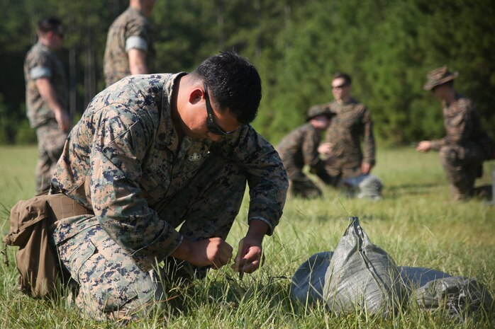Staff Sgt. Steve Gomez wires detonation cord during a tool familiarization range aboard MCAS Beaufort July11. The range was conducted to familiarize the technicians with the gear they utilize during operations. Gomez is an Explosive Ordnance Disposal Marine with MCAS Beaufort.