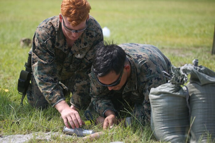 Sgt. Josh Alexander, left, and Staff Sgt. Steve Gomez measure a piece of ordnance during a tool familiarization range aboard MCAS Beaufort July 11. The Marines conducted the range to maintain proficiency on the tools and equipment they use. Alexander and Gomez are with MCAS Beaufort explosive ordnance disposal.