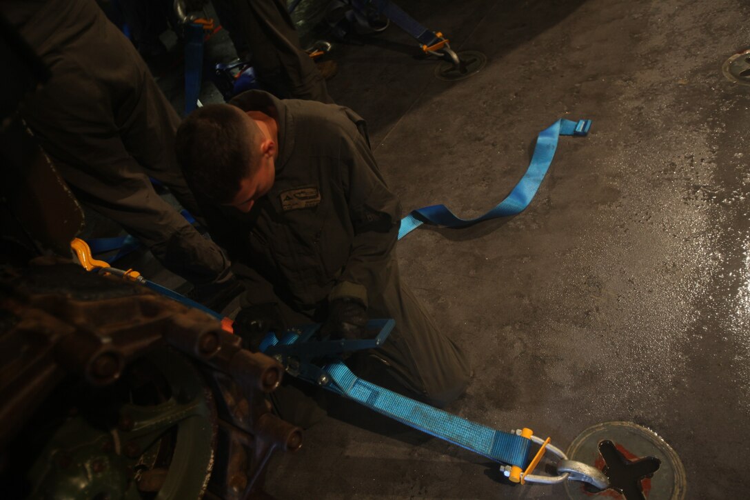 U.S. Marine Corps Lance Cpl. Alex Rojos, a crew chief with Combat Assault Company, 3rd Marine Regiment, tightens straps on an AAV-P7/A1 assault amphibious vehicles aboard the Royal Australian Navy landing helicopter dock ship HMAS Adelaide (L01) as part of Rim of the Pacific (RIMPAC) exercise off the coast of Marine Corps Base Hawaii July 10, 2018. RIMPAC provides high-value training for task-organized, highly capable Marine Air-Ground Task Force and enhances the critical crisis response capability of U.S. Marines in the Pacific. Twenty-five nations, 46 ships, five submarines, about 200 aircraft and 25,000 personnel are participating in RIMPAC from June 27 to Aug. 2 in and around the Hawaiian Islands and Southern California. The world's largest international maritime exercise, RIMPAC provides a unique training opportunity while fostering and sustaining cooperative relationships among participants critical to ensuring the safety of sea lanes and security on the world's oceans.