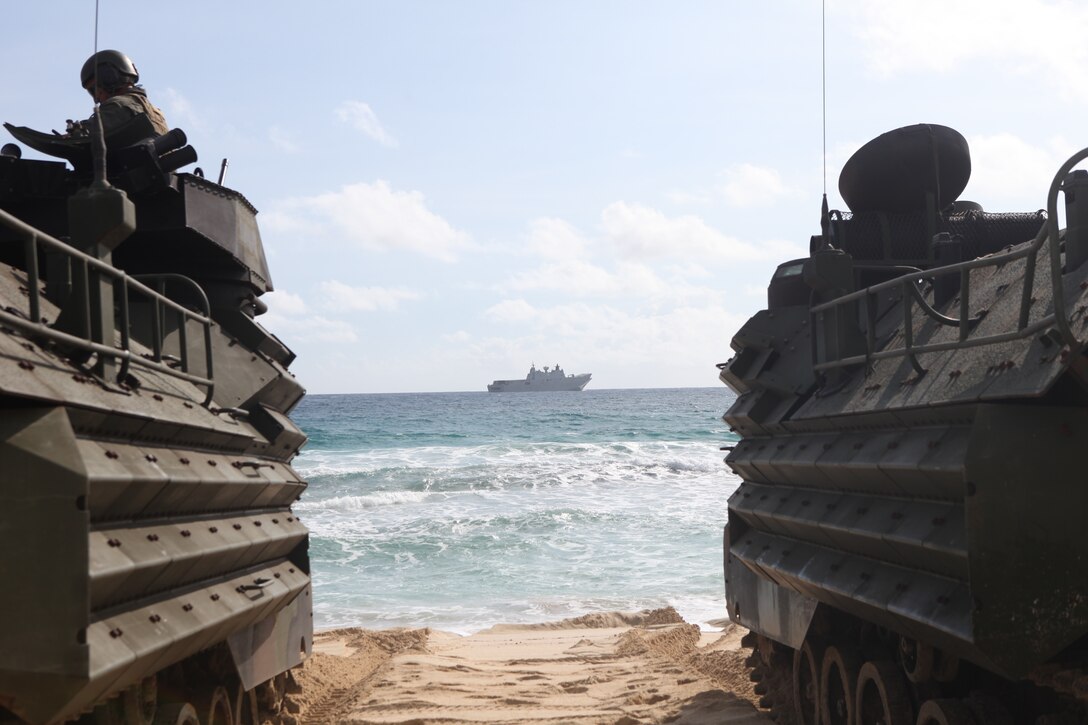 U.S. Marines with Combat Assault Company, 3rd Marine Regiment, stage AAV-P7/A1 assault amphibious vehicles at Pyramid Rock Beach prior to embarking onto the Royal Australian Navy landing helicopter dock shop HMAS Adelaide (L01) as part of Rim of the Pacific (RIMPAC) exercise on Marine Corps Base Hawaii July 10, 2018. RIMPAC provides high-value training for task-organized, highly capable Marine Air-Ground Task Force and enhances the critical crisis response capability of U.S. Marines in the Pacific. Twenty-five nations, 46 ships, five submarines, about 200 aircraft and 25,000 personnel are participating in RIMPAC from June 27 to Aug. 2 in and around the Hawaiian Islands and Southern California. The world's largest international maritime exercise, RIMPAC provides a unique training opportunity while fostering and sustaining cooperative relationships among participants critical to ensuring the safety of sea lanes and security on the world's oceans.