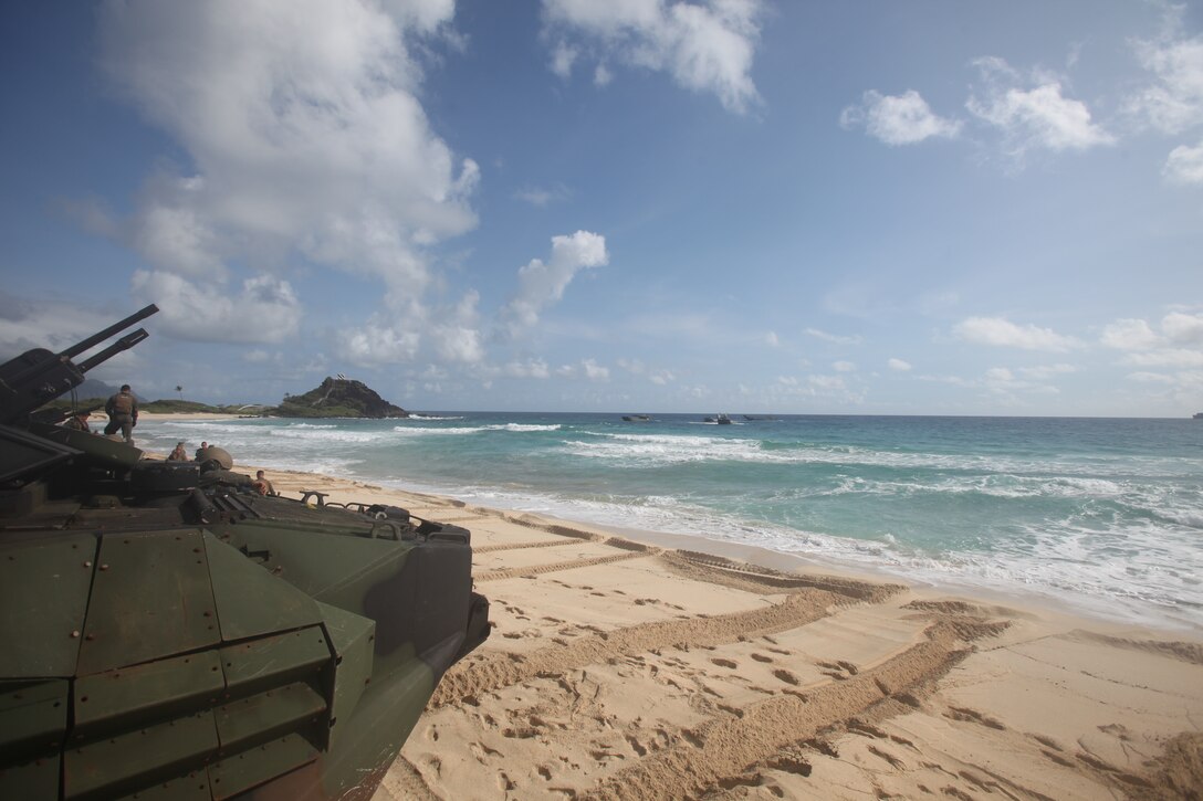 U.S. Marines with Combat Assault Company, 3rd Marine Regiment, stage AAV-P7/A1 assault amphibious vehicles at Pyramid Rock Beach prior to embarking onto the Royal Australian Navy landing helicopter dock ship HMAS Adelaide (L01) as part of Rim of the Pacific (RIMPAC) exercise on Marine Corps Base Hawaii July 10, 2018. RIMPAC provides high-value training for task-organized, highly capable Marine Air-Ground Task Force and enhances the critical crisis response capability of U.S. Marines in the Pacific. Twenty-five nations, 46 ships, five submarines, about 200 aircraft and 25,000 personnel are participating in RIMPAC from June 27 to Aug. 2 in and around the Hawaiian Islands and Southern California. The world's largest international maritime exercise, RIMPAC provides a unique training opportunity while fostering and sustaining cooperative relationships among participants critical to ensuring the safety of sea lanes and security on the world's oceans.
